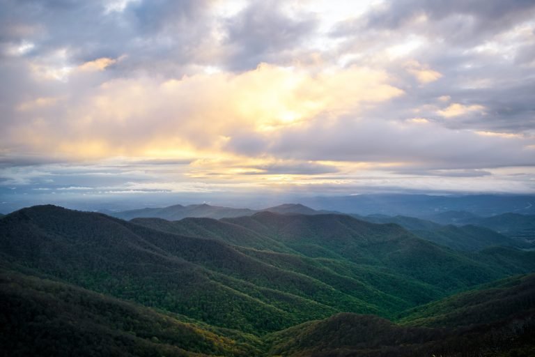 green mountains under white clouds during daytime