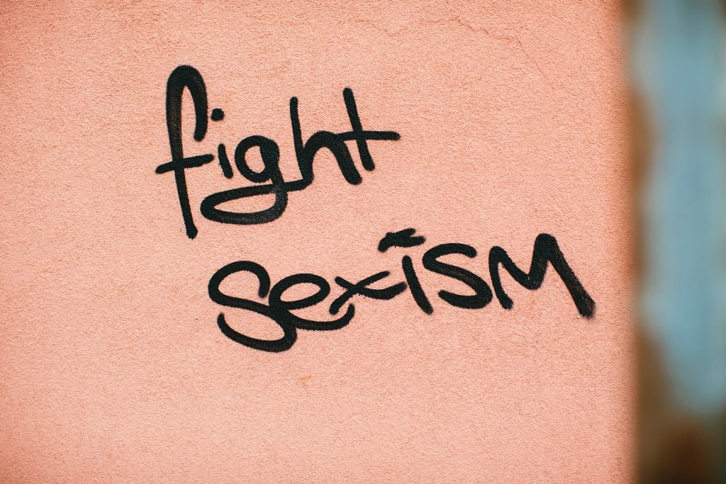 fight sexism words on orange background